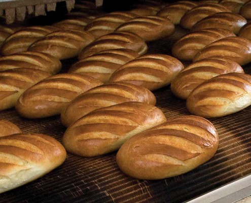 Loaves of bread in an industrial oven.